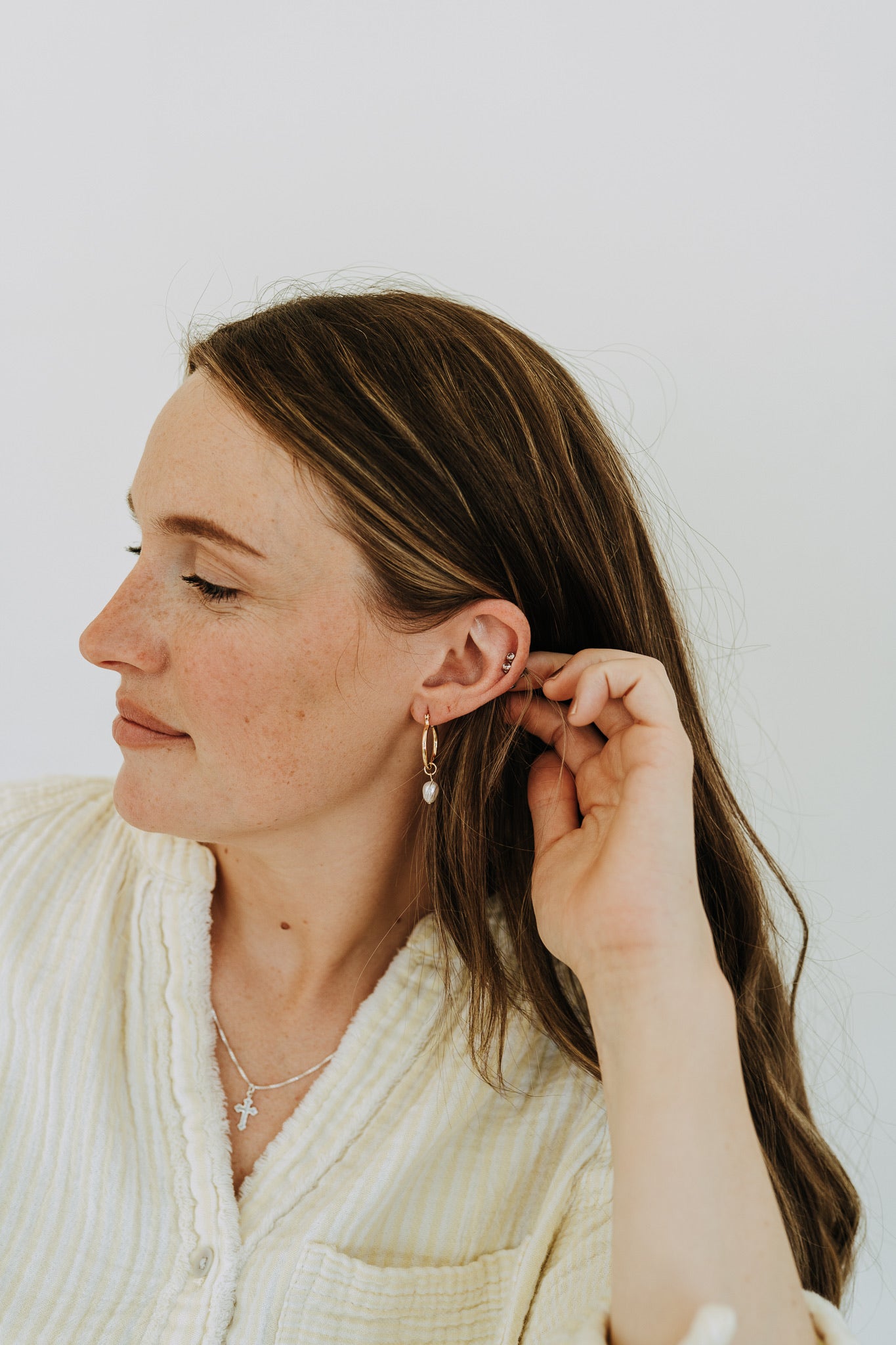 Small gold hoop earrings with natural pearl drops for everyday wear